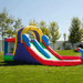 Avyna Royal Wave Bounce House 1 with Dual Lane Water Slide Backyard Side View with Water Cannon Spraying