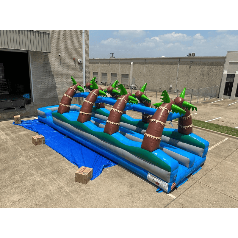 Outside Far View of Dura Lite Inflated 2 Lane Slip and Slide with Palm Trees